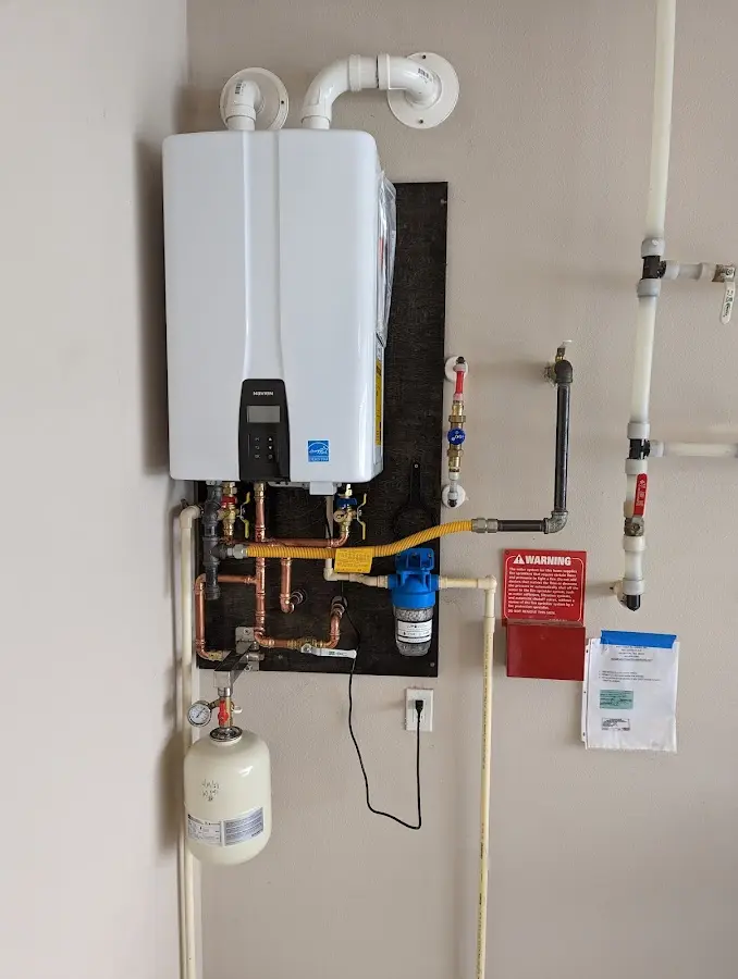 Professional plumber installing copper piping in a Bethel Park home